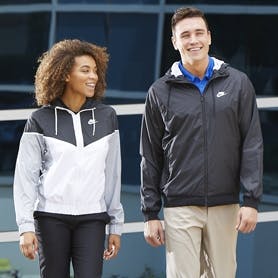 Two sports fans walking together and wearing Nike fanwear