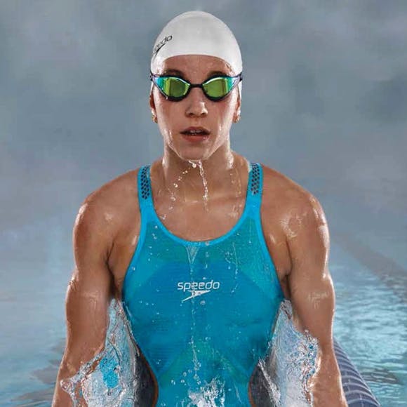 Girl swimmer wearing a Speedo suit and cap