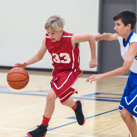 Club select basketball player dribbling down the court