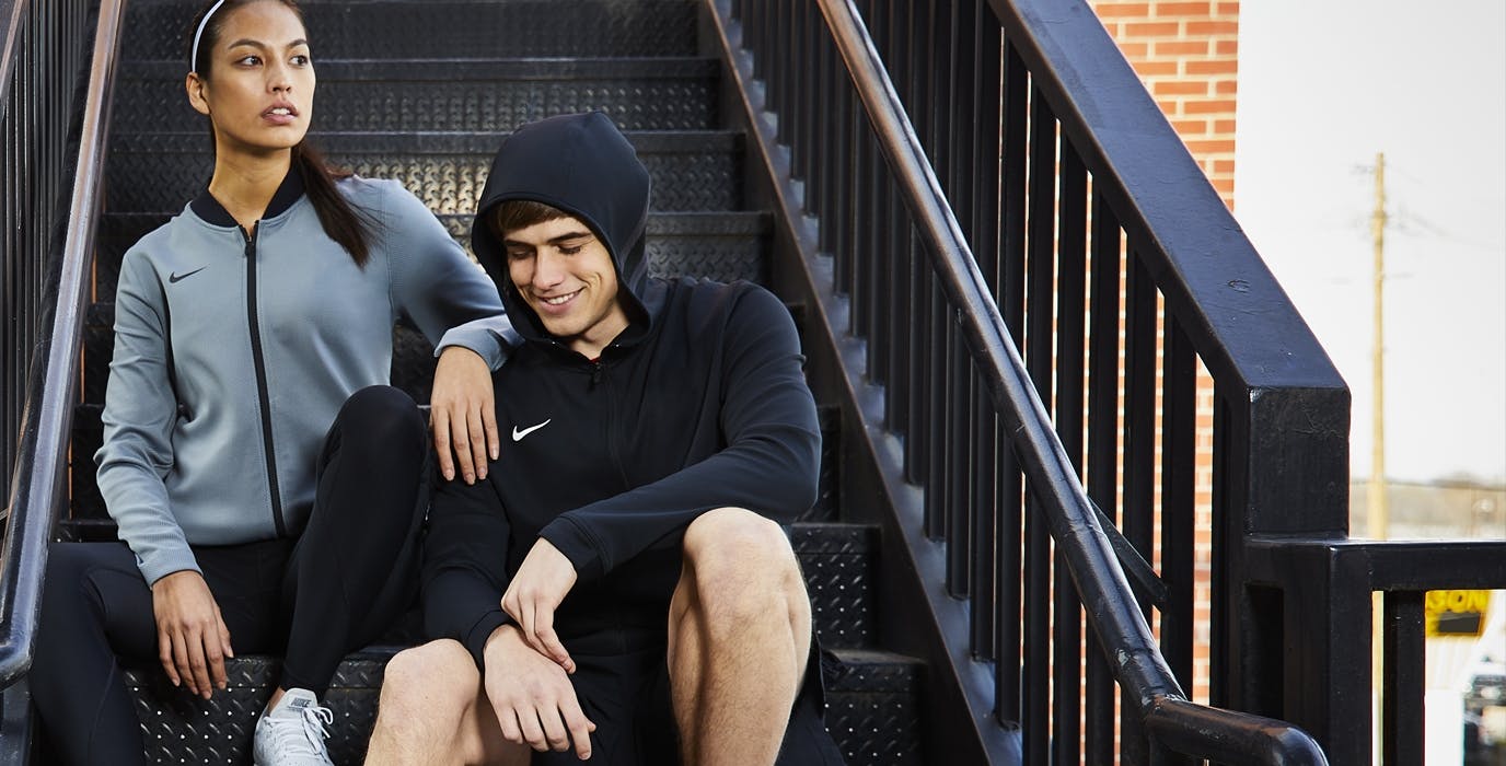 High school athletes sitting on a stairs and wearing Nike team apparel