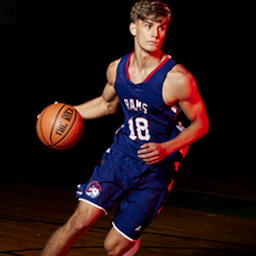 Boy basketball player dribbling a basketball and wearing a custom BSN SPORTS Victory uniform