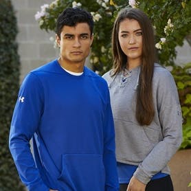 A boy student and a girl student wearing Under Armour fanwear